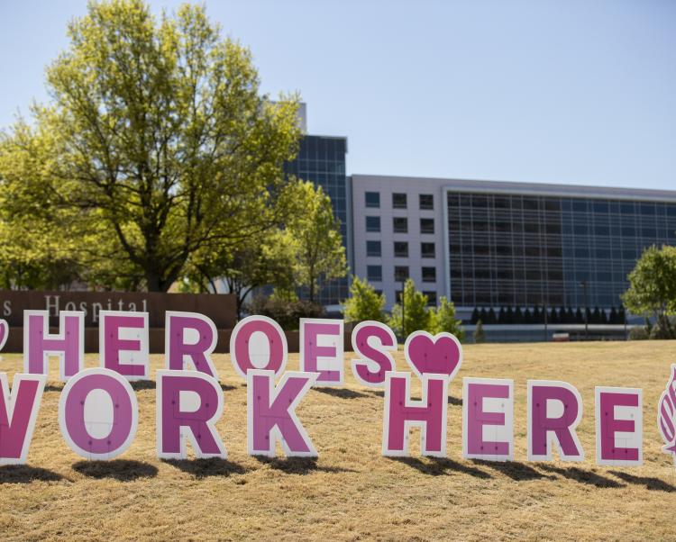 lawn letters spelling out the words 'heroes work here' in front of one of Saint Francis' hospitals